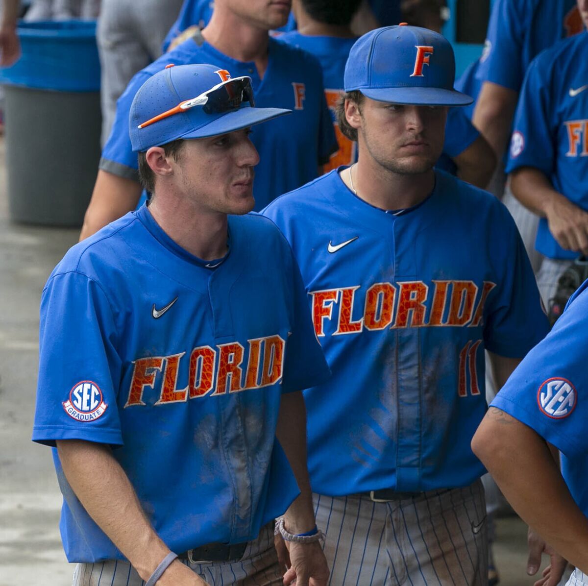 Florida's Jacob Young (1) and Nathan Hickey (11) react following to the Gators 19-1 loss to South Alabama in an NCAA regional tournament college baseball game against South Alabama at Florida Ballpark, Saturday, June 5, 2021, in Gainesville, Fla. (Cyndi Chambers/Ocala Star-Banner via AP)