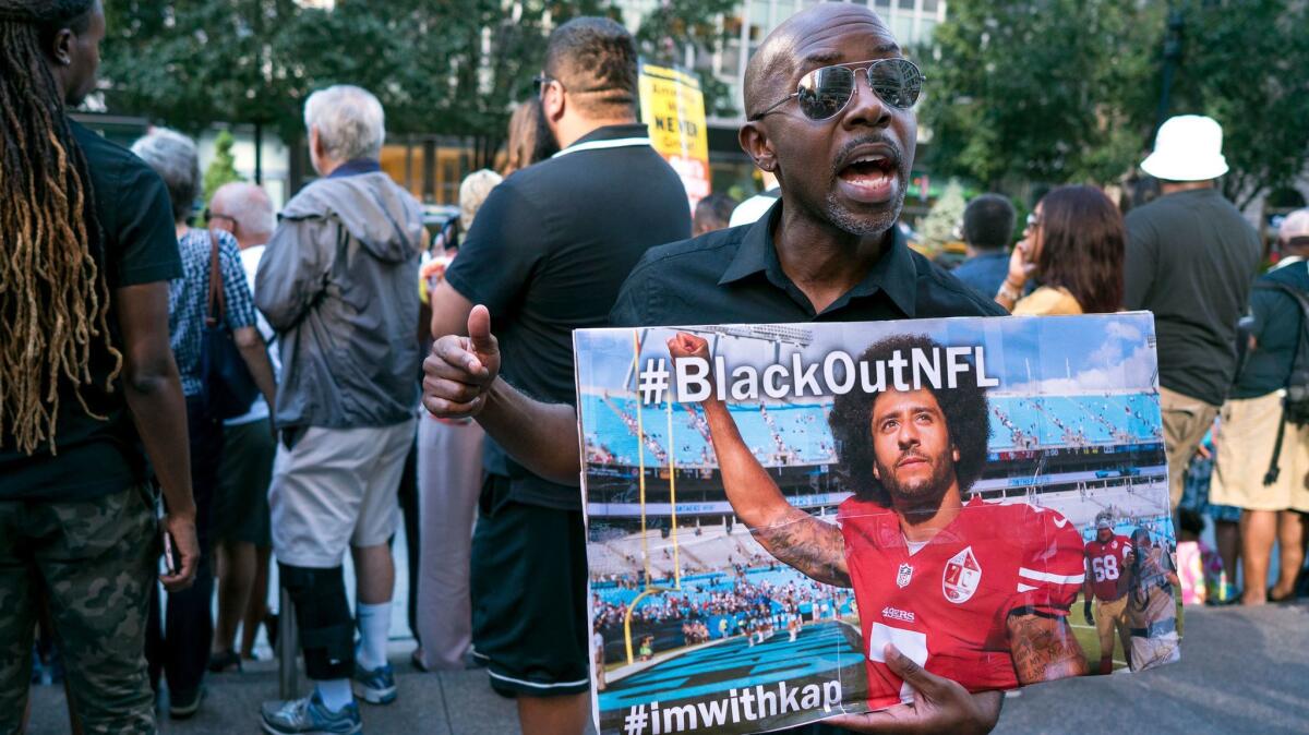 Eric Hamilton of New York joins others gathered in front of NFL headquarters in Manhattan on Aug. 23 in support of unsigned NFL quarterback Colin Kaepernick.