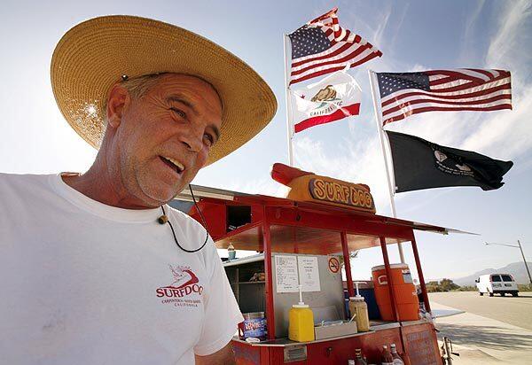 Bill Connell, 55, stands in front of his Surf Dog stand in Carpinteria. He's been in the hot dog business since he left his native New Jersey when he was 38.