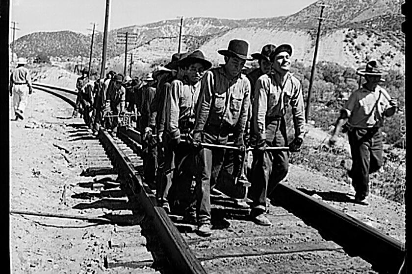 An Indian "section gang" forced to work on the Atchison, Topeka, and Santa Fe Railroad track in El Cajon, California, 1943. photo by Jack Delano, Library of Congress