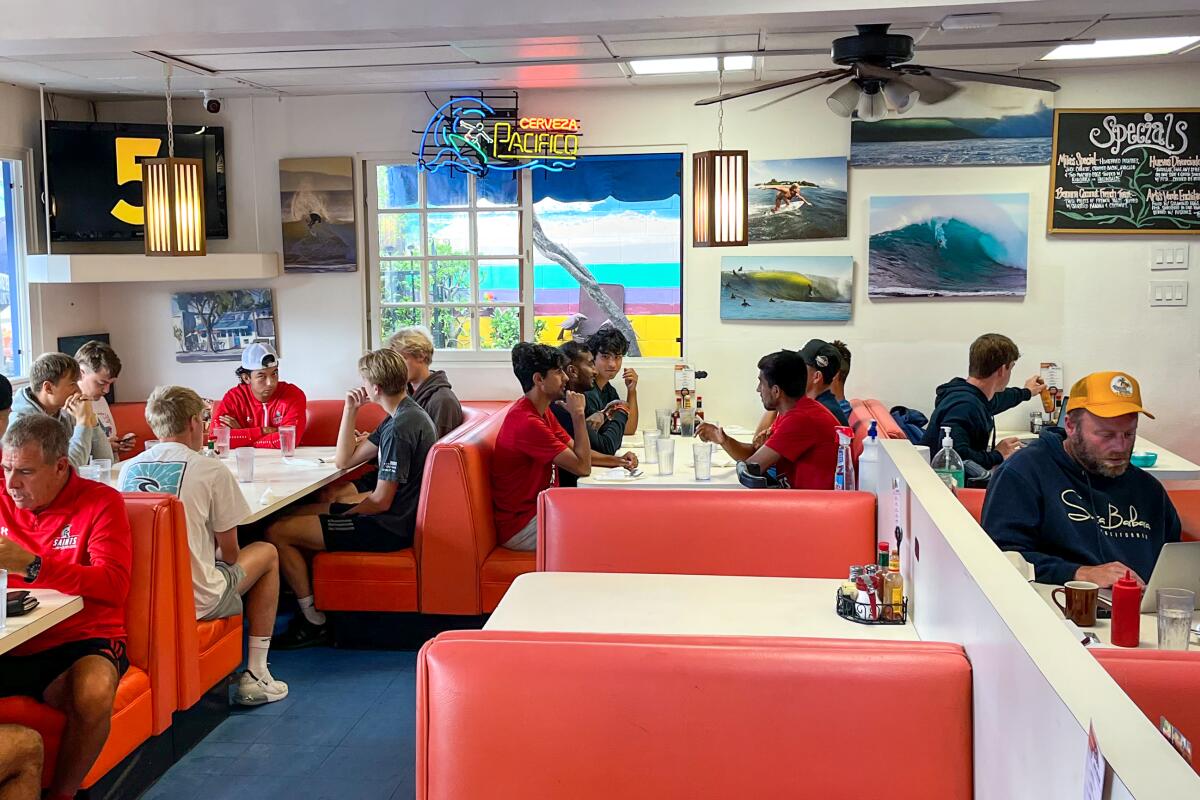 Diners sit at red booths inside Esau's Cafe