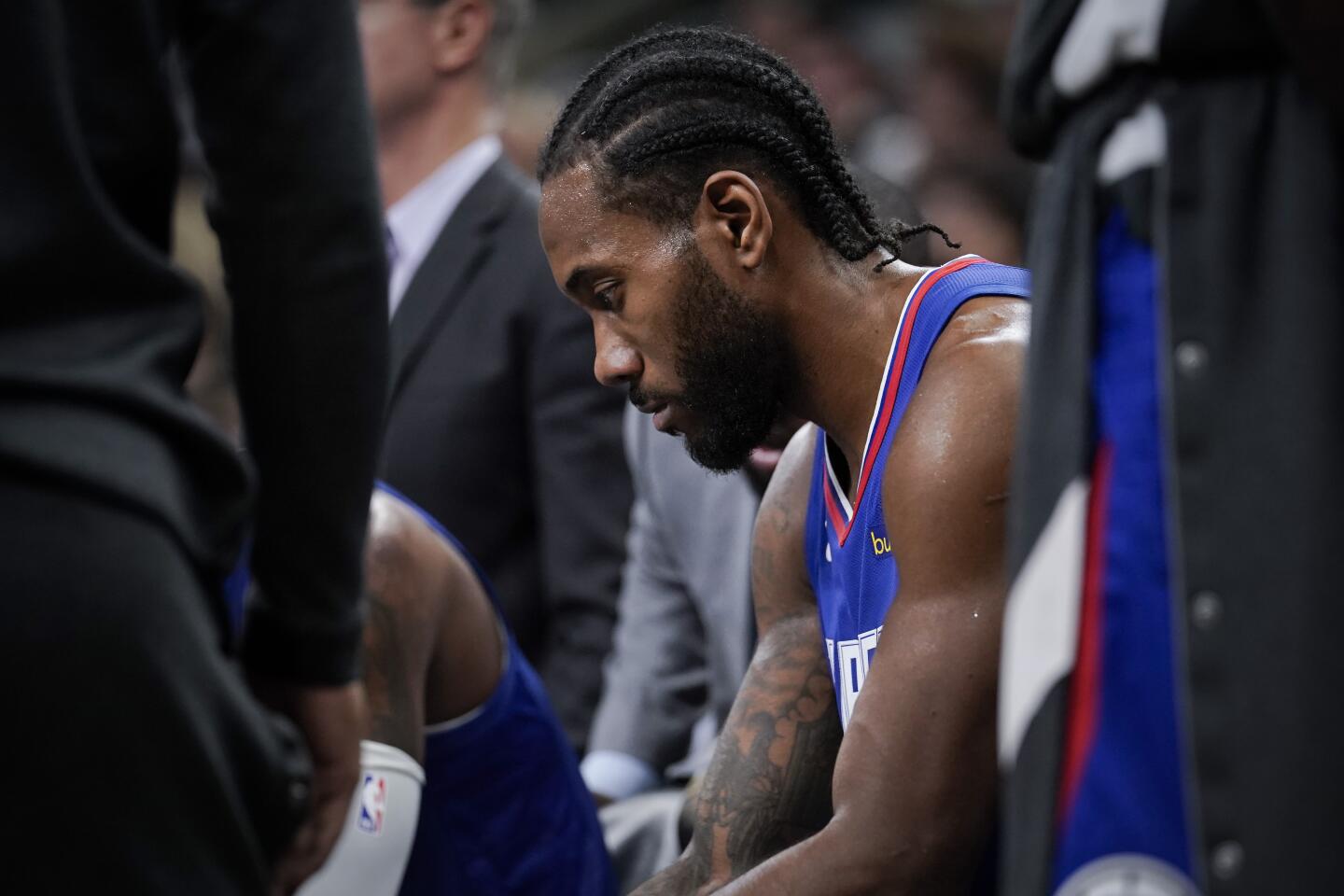 Clippers forward Kawhi Leonard sits on the bench during a timeout in the second half of a game against the Spurs on Nov. 29.