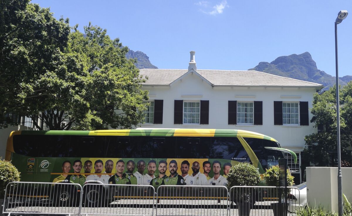 The team bus for the South African cricket team is parked outside The Vineyard Hotel in Cape Town, South Africa, Sunday, Dec. 6, 2020. Two members of the England touring party in South Africa have returned "unconfirmed positive tests" for COVID-19, the England and Wales Cricket Board said Sunday, as the first one-day international was canceled because of a virus outbreak at the hotel where both teams are staying. (AP Photo/Halden Krog)