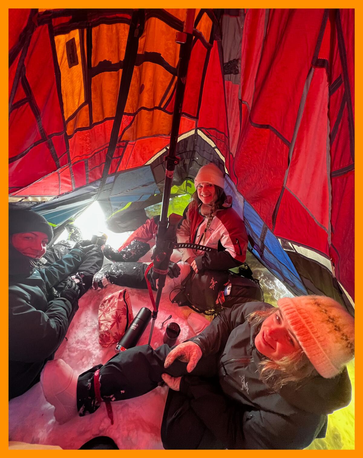 Three woman inside a small tent.