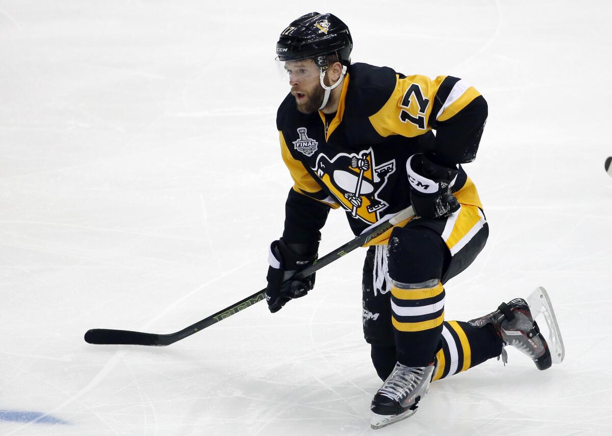 Pittsburgh's Bryan Rust rises slowly after being checked to the ice by San Jose's Patrick Marleau.