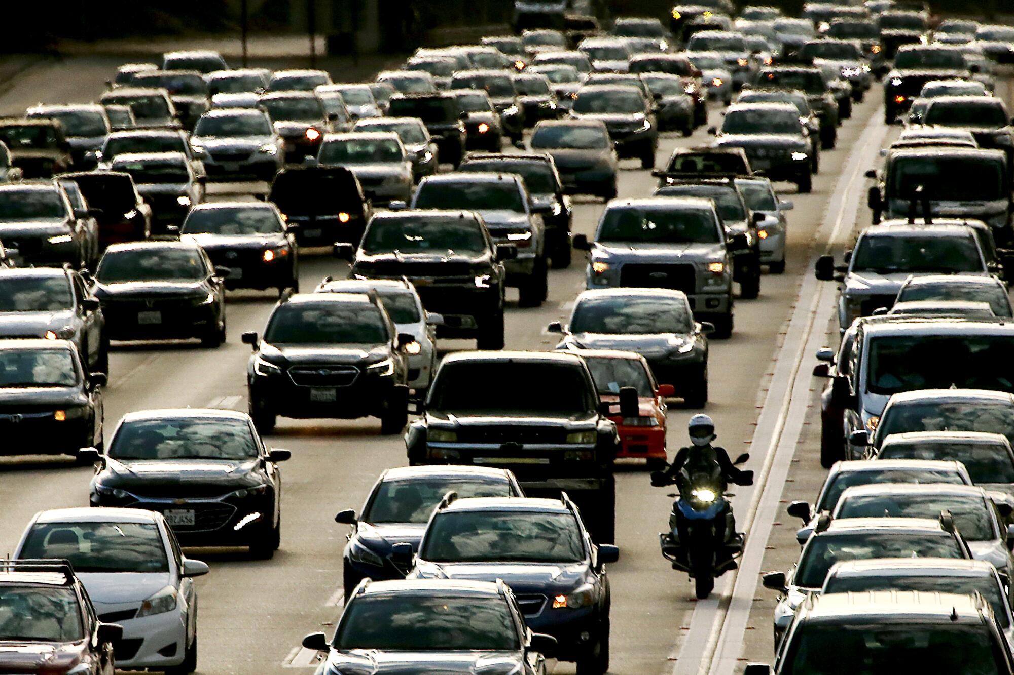 Traffic streams down a crowded freeway.