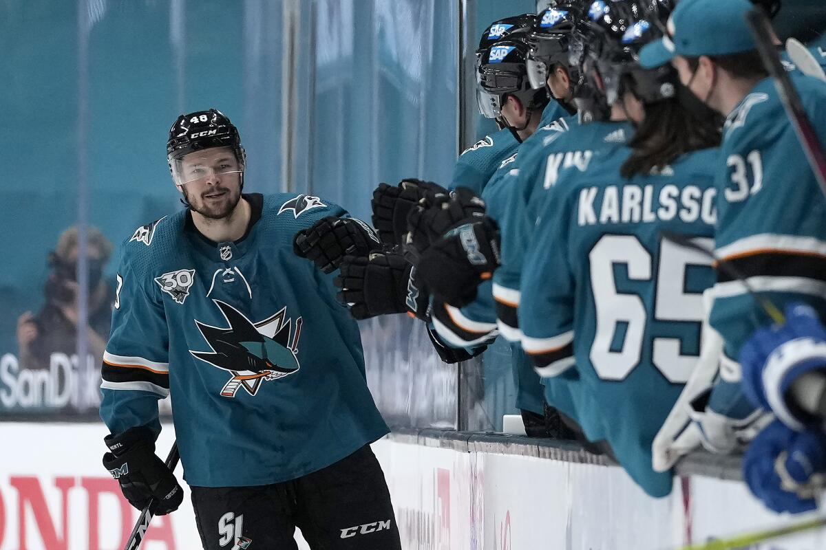 San Jose Sharks center Tomas Hertl (48) is congratulated by teammates on the bench after scoring a goal against the Colorado Avalanche during the second period of an NHL hockey game in San Jose, Calif., on Wednesday, May 5, 2021. (AP Photo/Tony Avelar)