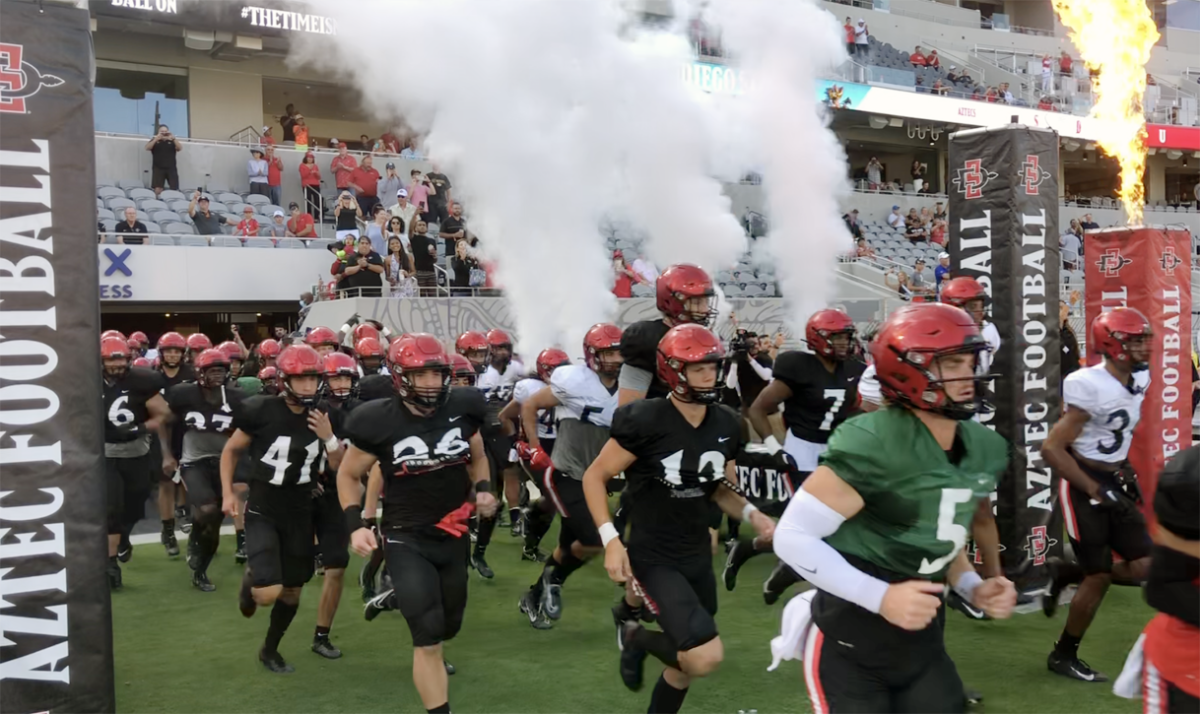 San Diego State players emerge from Hype Tunnel located beneath stands at 50-yard line.