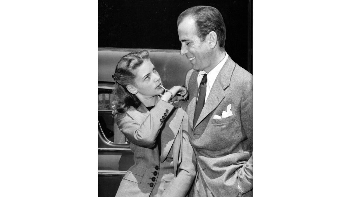 May 25, 1945: Humphrey Bogart and Lauren Bacall are seen at Union Station after returning to California after their wedding in Ohio. Bacall is blowing a small whistle attached to her bracelet.