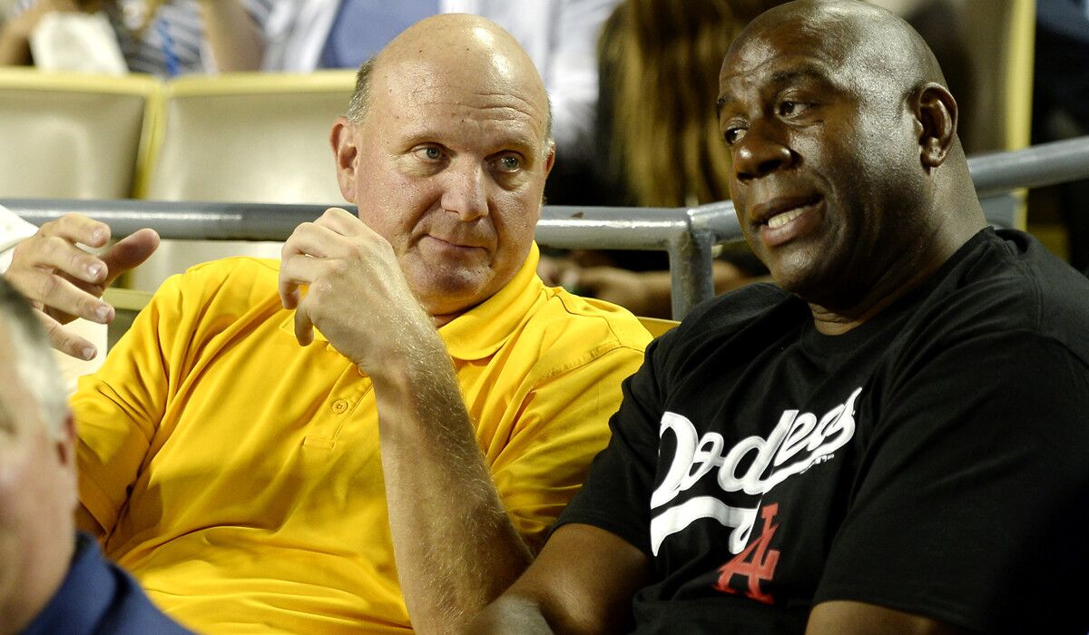 Clippers owner Steve Ballmer takes in a Dodgers game with part owner and former Lakers great Magic Johnson.