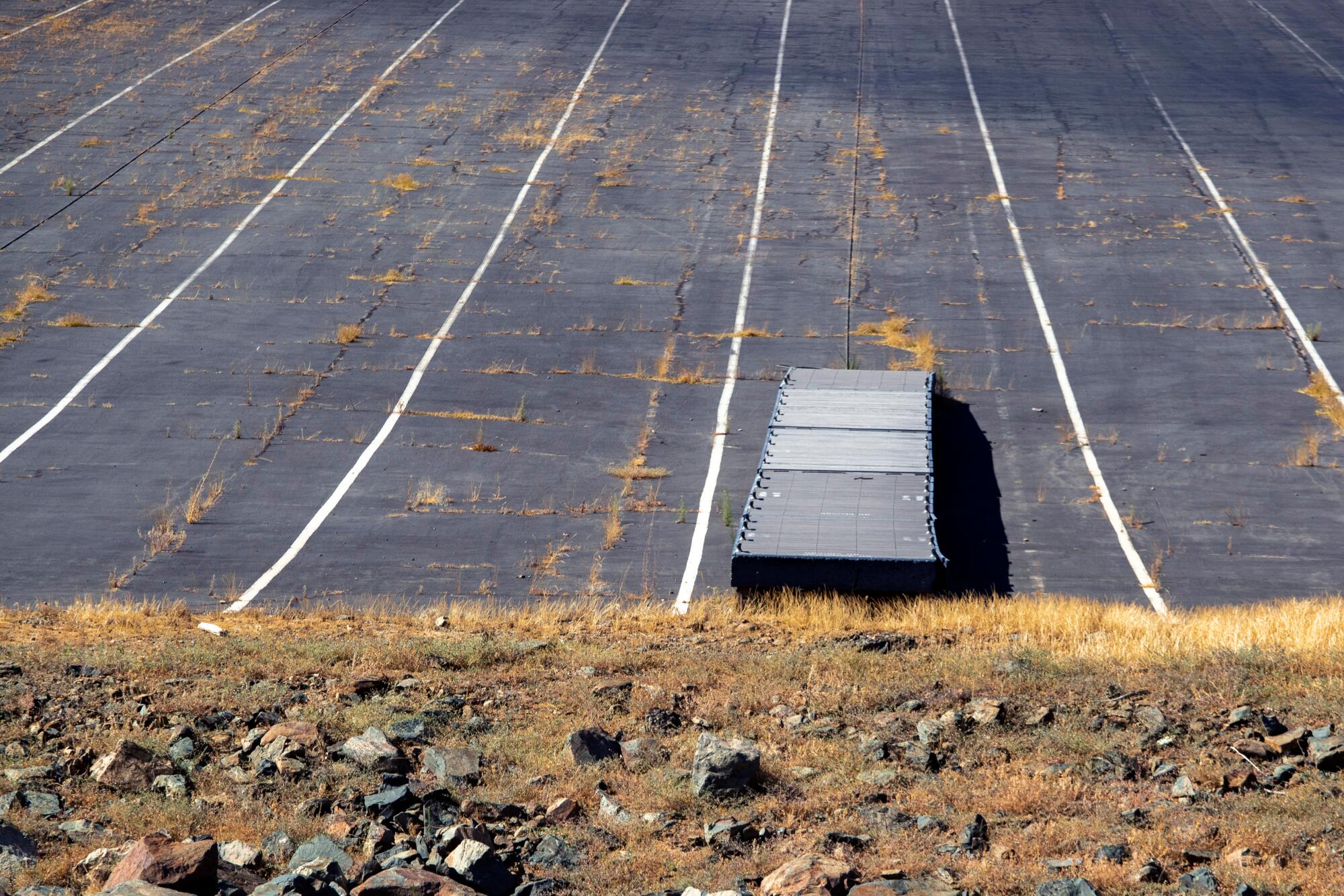 A boat dock is left high and dry on the shoreline at Lake Oroville.