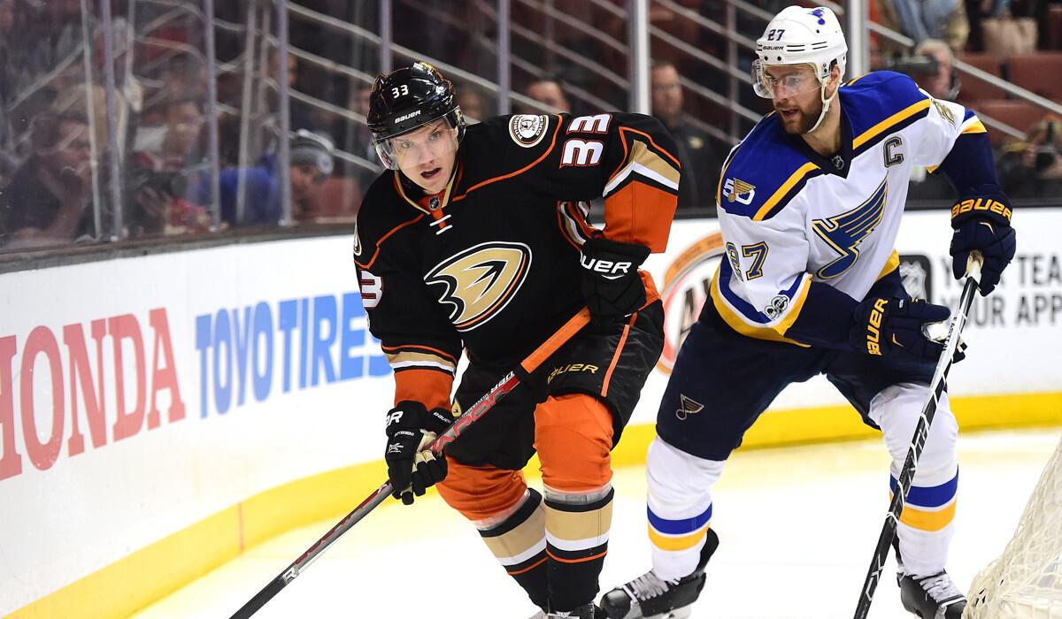 Ducks' Jakob Silfverberg (33) looks to pass as he is chased by St. Louis Blues' Alex Pietrangelo during the first period on Sunday.
