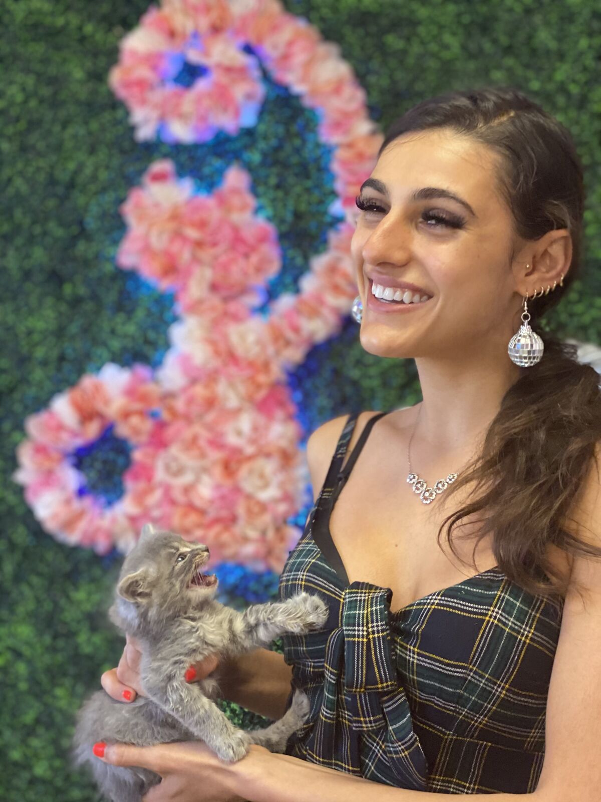 Tara Boornazian, general manager of Cat Palace by Champagne Queen, with one of the adoptable kittens.