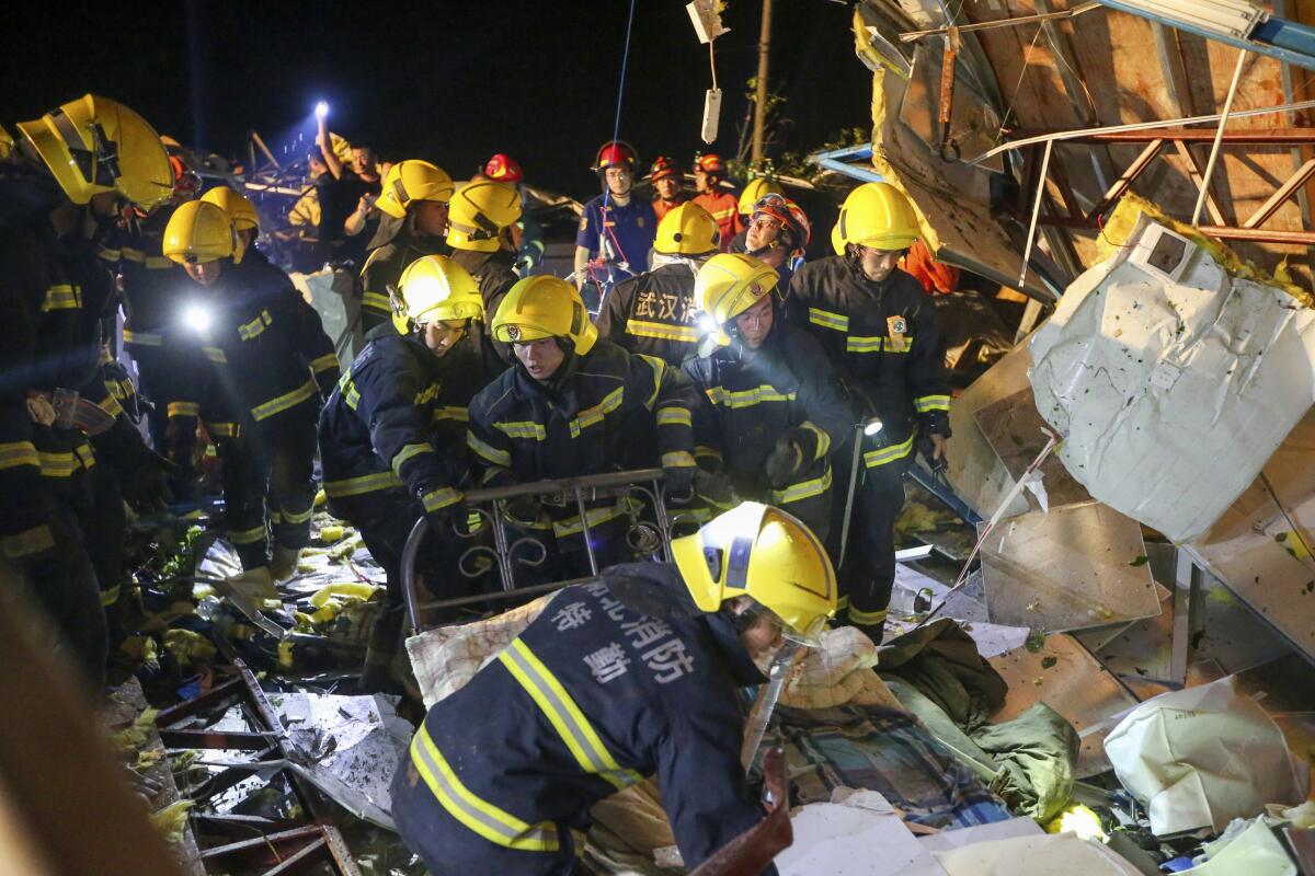 Rescue workers search through the wreckage of buildings destroyed by a reported tornado