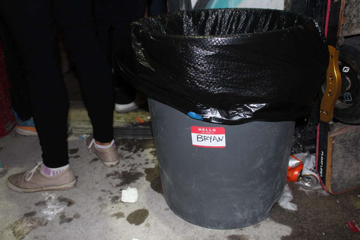 A trash can with a "Bryan" name tag.