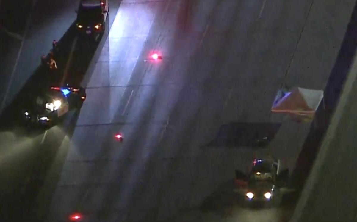 An aerial view of police cars on a freeway after a fatal collision