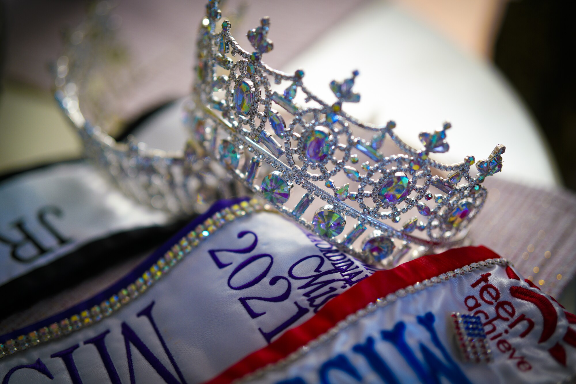 a close up shot of a pageant crown and sashes