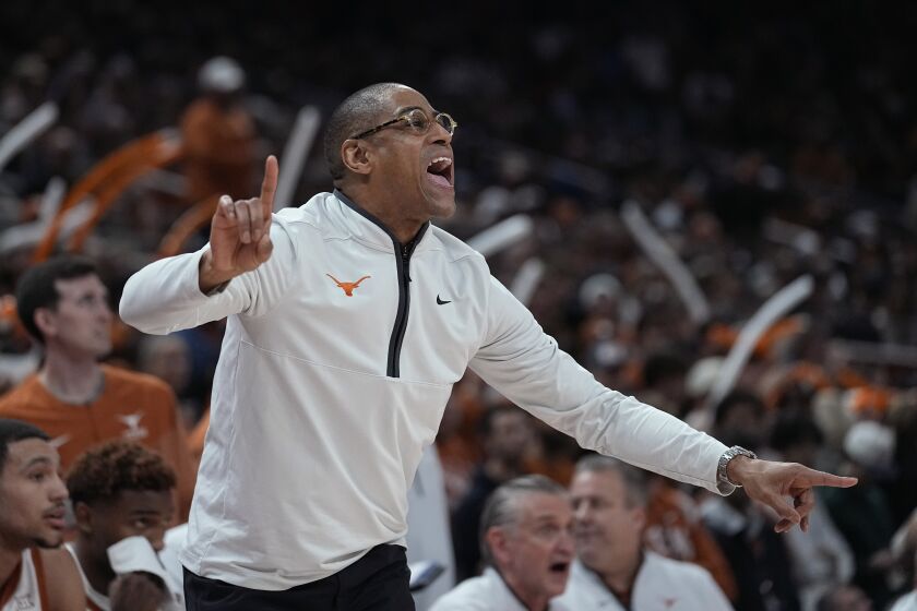 Texas interim coach Rodney Terry signals to players during the first half of the team's NCAA college basketball game against Oklahoma State in Austin, Texas, Tuesday, Jan. 24, 2023. (AP Photo/Eric Gay)