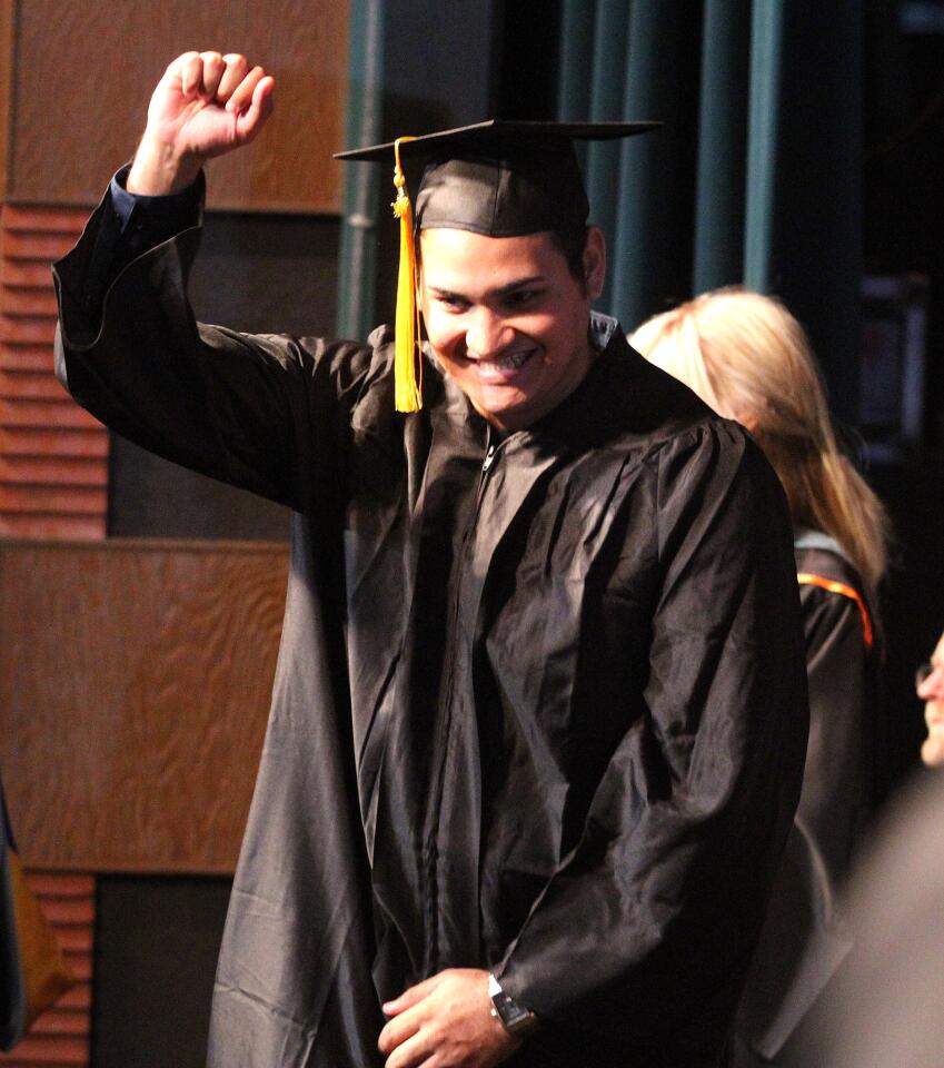Graduate Antonio Rodriguez, of the Burbank Adult School, pumps his fist after his name is read at the graduation at Luther Burbank Middle School on Wednesday, May 28, 2014.