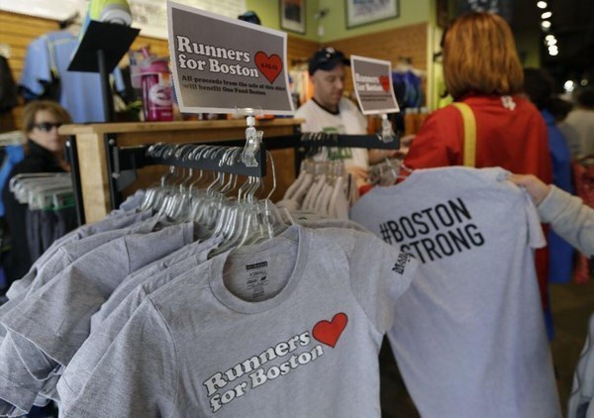 Shoppers returned to the Marathon Sports shop Thursday in downtown Boston as businesses that had been closed since the Boston Marathon bombings were allowed to reopen. The bombings apparently did not affect Americans' view of the economy, according to the Thomson Reuters/University of Michigan Survey of Consumers.