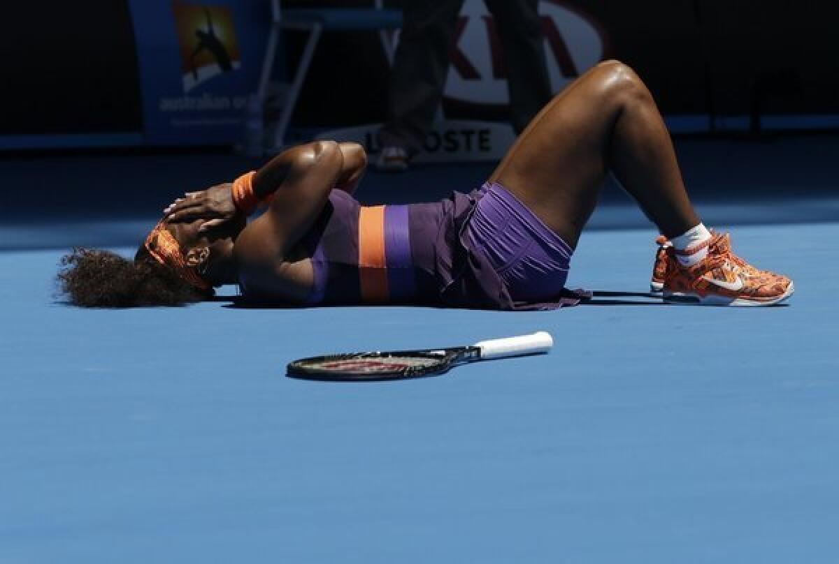 Serena Williams lies on the court after hurting her ankle in the first set.