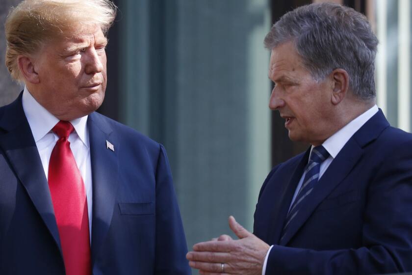 FILE - In this July 16, 2018 file photo, U.S. President Donald Trump, left, talks with Finnish President Sauli Niinisto as they pose for a photo in Helsinki, Finland. Niinisto said in an interview published on Sunday, Nov. 18, 2018 that he briefed Trump in the wake of the California wildfires on how the Nordic country effectively monitors its substantial forest resources with a well-working surveillance system. (AP Photo/Pablo Martinez Monsivais, File)