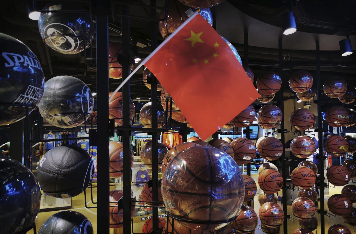 A Chinese flag is seen amid basketballs in the NBA flagship retail store in Beijing.