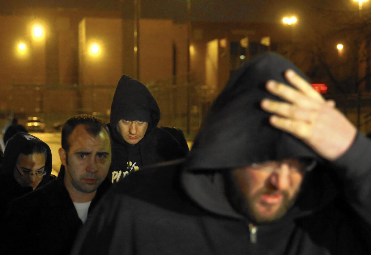 Chicago police Officer Jason Van Dyke, background center, is charged with first-degree murder in the October 2014 death of Laquan McDonald. Van Dyke said McDonald appeared to be a threat, but video of the incident shows the teen walking away when he was shot.