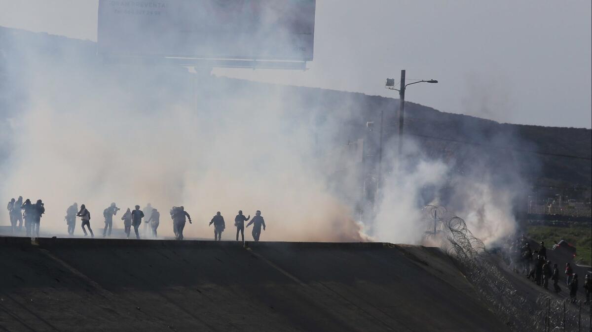 Border police fire tear gas to prevent groups of people from crossing the U.S.-Mexico border on Nov. 25.