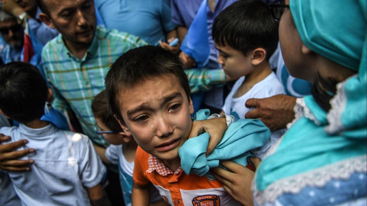 A boy reacts during a protest of China's treatment of ethnic Uighur Muslims, in front of the Chinese consulate in Istanbul, on July 5.