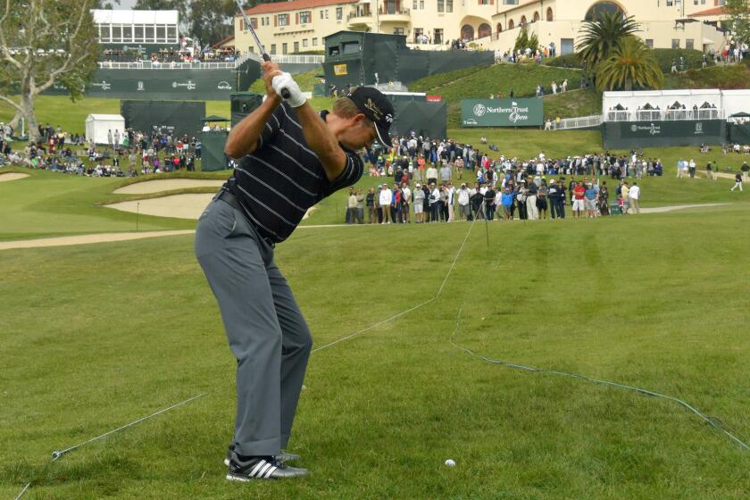 Retief Goosen makes his approach shot on the ninth hole during the third round of the Northern Trust Open at Riviera Country Club on Saturday.
