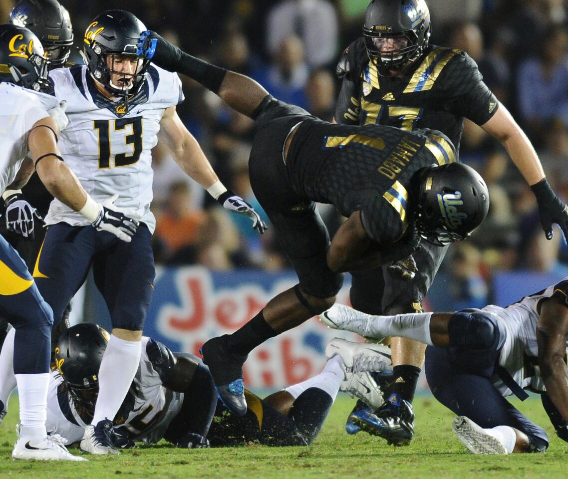 UCLA running back Soso Jamabo, who finished with 79 yards rushing in 18 attempts, is upended after picking up yards against California.