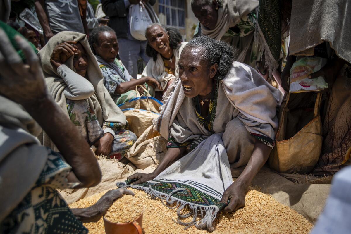Ethiopian woman arguing with others over food supplies.