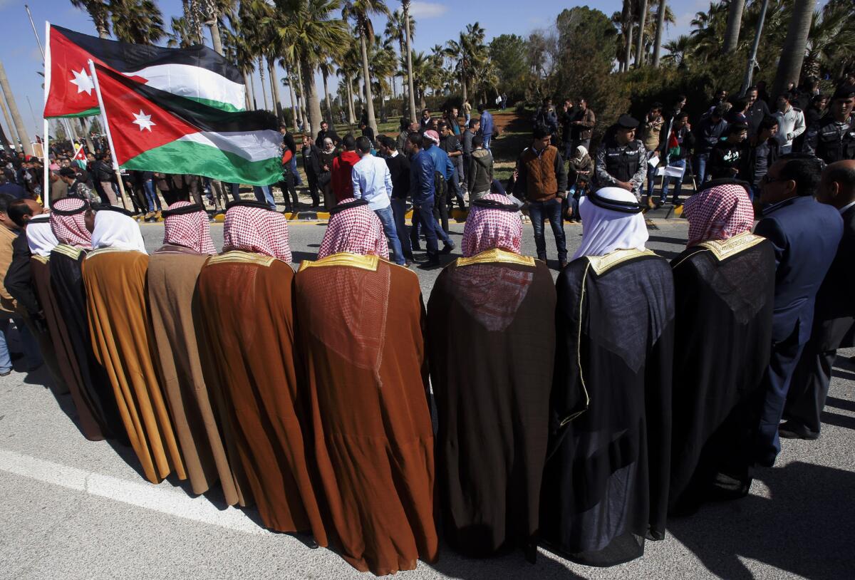 Jordanians show their support for the government against terrorism as they await King Abdullah II's return from the U.S. at Queen Alia International Airport in Amman on Feb. 4.
