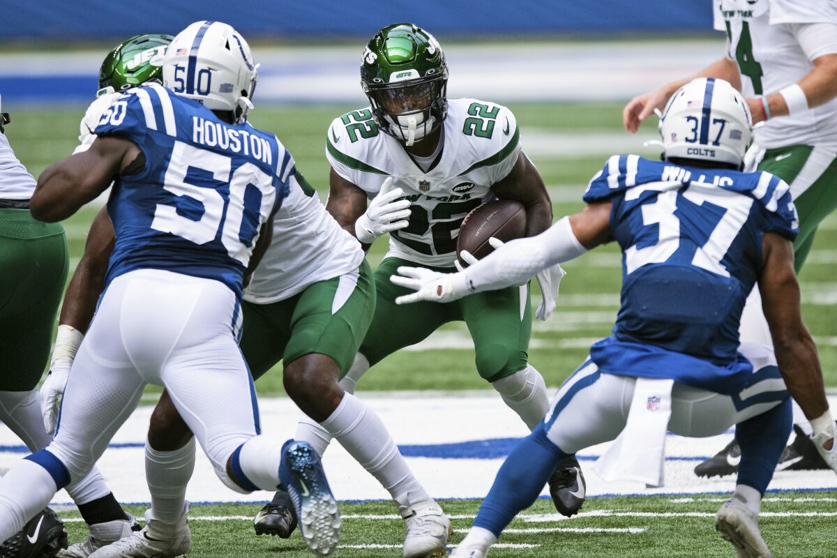 FILE - In this Sept. 27, 2020, file photo, New York Jets running back La'Mical Perine (22) looks for an opening in the line during an NFL football game between the Indianapolis Colts in Indianapolis. Perine was drafted in April to be the New York Jets' running back of the future. Well, that might already be now. And a bit sooner than many probably expected. (AP Photo/Zach Bolinger, File)
