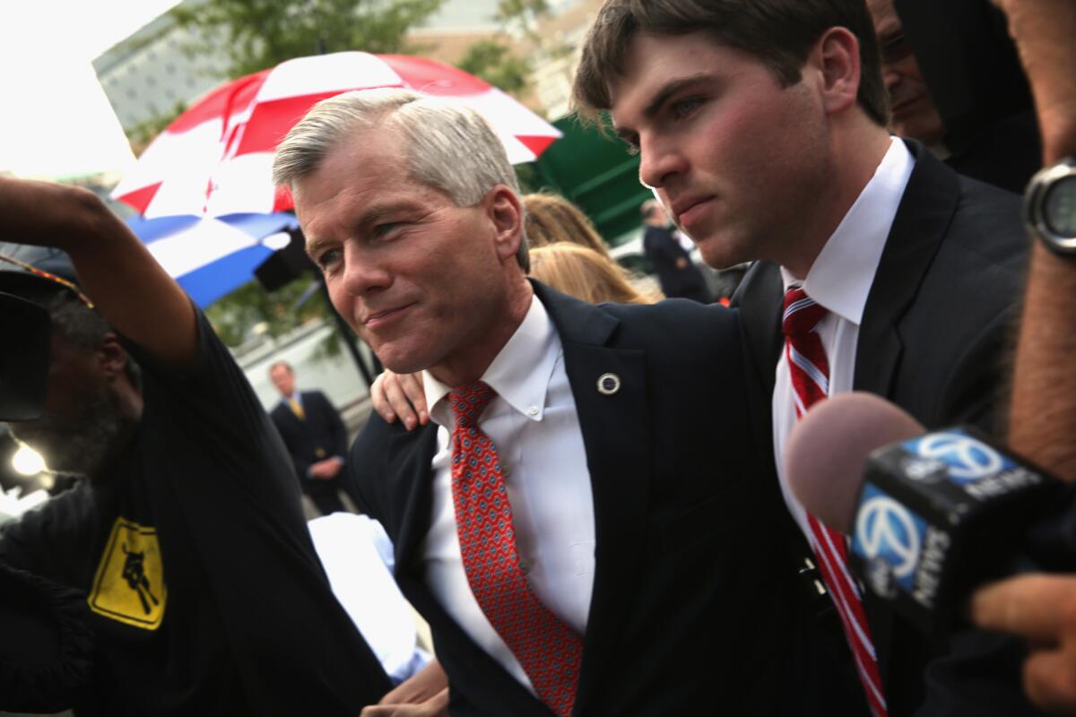 Former Virginia Gov. Bob McDonnell, shown with son Bobby in 2014, was convicted that year of 11 counts of corruption and sentenced to two years in prison. The Supreme Court has agreed to hear his appeal.