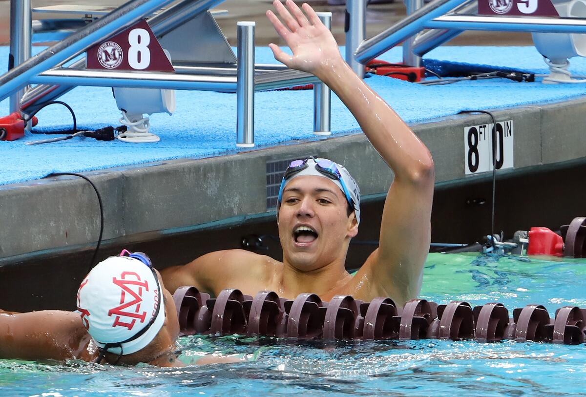 Newport Harbor's Aidan Arie celebrates after winning the consolation final in the 200 yard freestyle on Saturday.