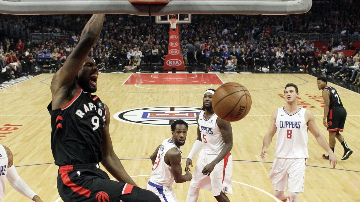Toronto Raptors' Serge Ibaka (9) dunks against the Clippers.