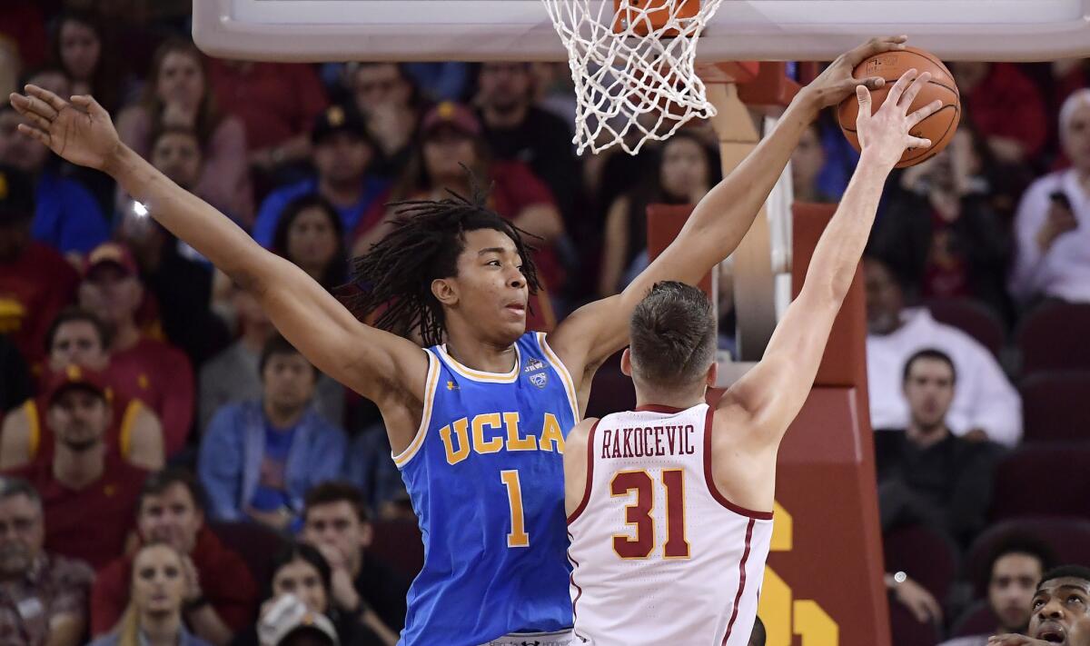 UCLA center Moses Brown blocks a shot by USC forward Nick Rakocevic.