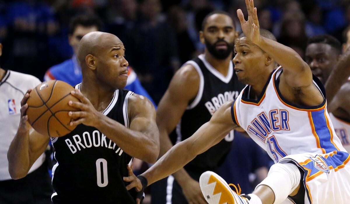 Nets guard Jarrett Jack (0) looks to pass around Thunder point guard Sebastian Telfair in the second half Friday night.