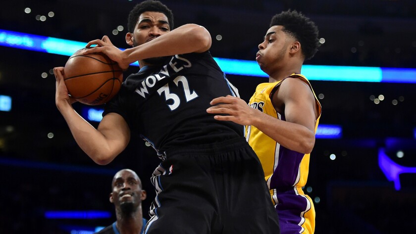 Timberwolves center Karl-Anthony Towns grabs a rebound in front of Lakers point guard D'Angelo Russell during an Oct. 28 game at Staples Center.
