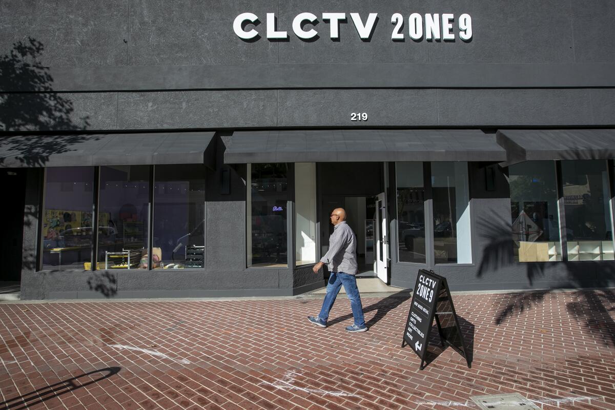 A man walks past the exterior of Collective2one9 in Santa Ana.
