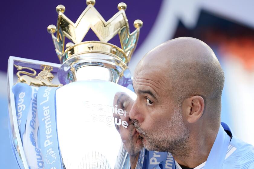 FILE - Manchester City's head coach Pep Guardiola celebrates with the Premier League trophy after the English Premier League soccer match between Manchester City and West Ham United at the Etihad Stadium in Manchester, England, Sunday, May 19, 2024. Manchester City clinched the English Premier League on Sunday after beating West Ham in their last match of the season. (AP Photo/Dave Thompson, File)
