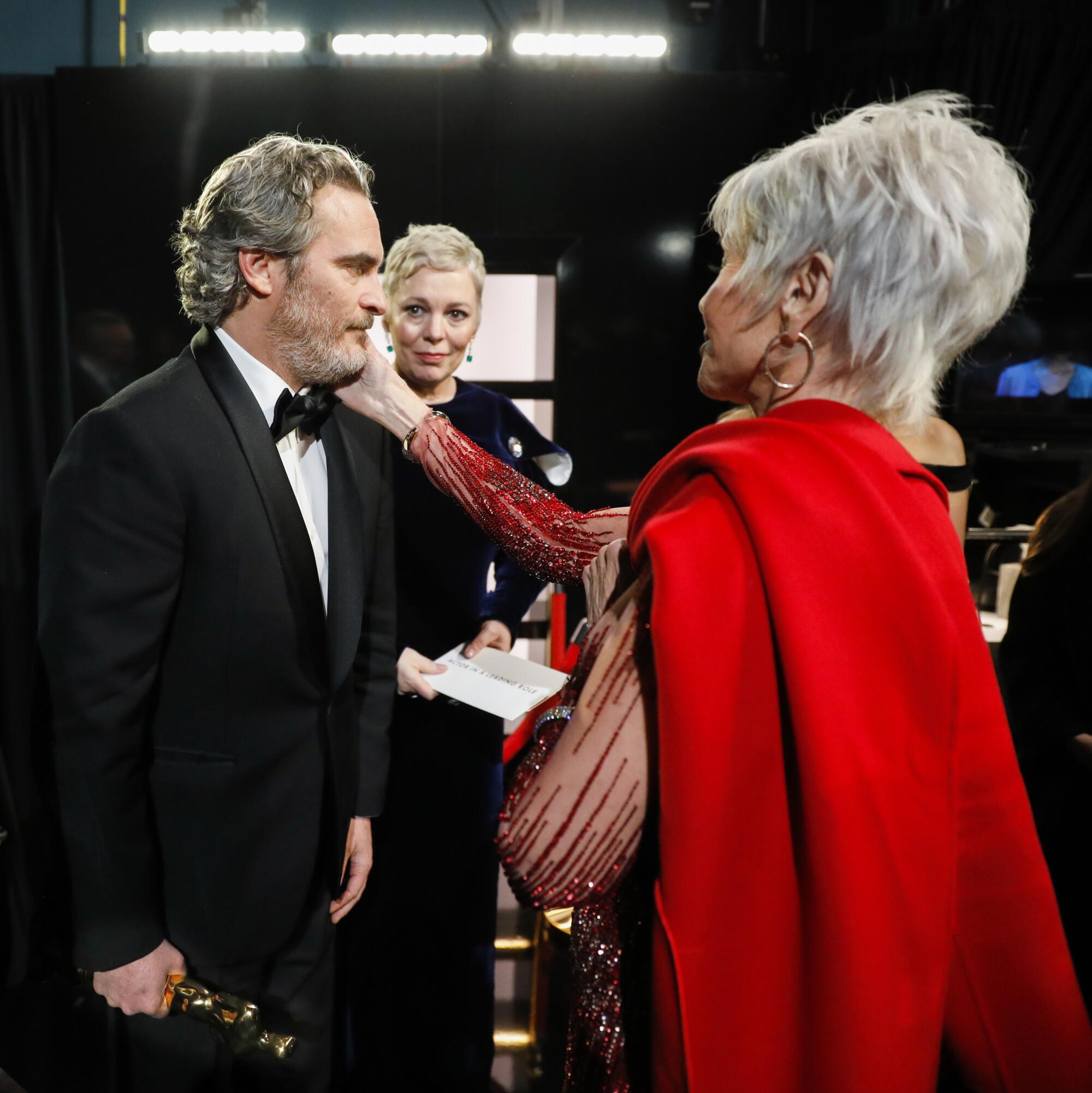 2020: Jane Fonda caresses the face of Joaquin Phoenix, who won the lead actor Oscar for “Joker,” backstage with Olivia Colman