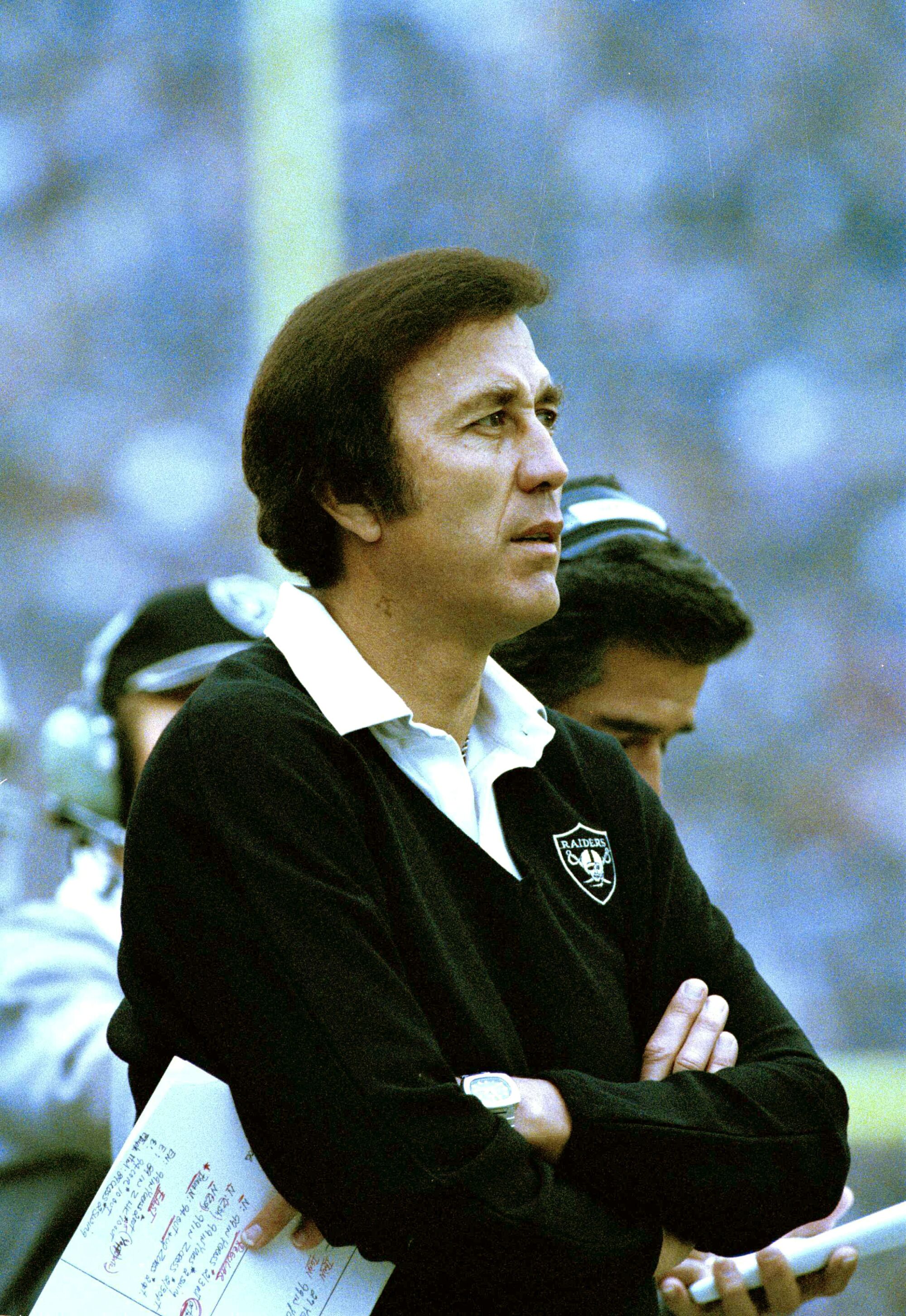 Tom Flores watches his Raiders play during a game in 1983.