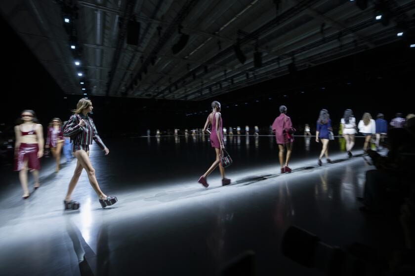 Models wear creations as part of the Gucci women's Spring Summer 2024 collection presented in Milan, Italy, Friday, Sept. 22, 2023. (AP Photo/Luca Bruno)