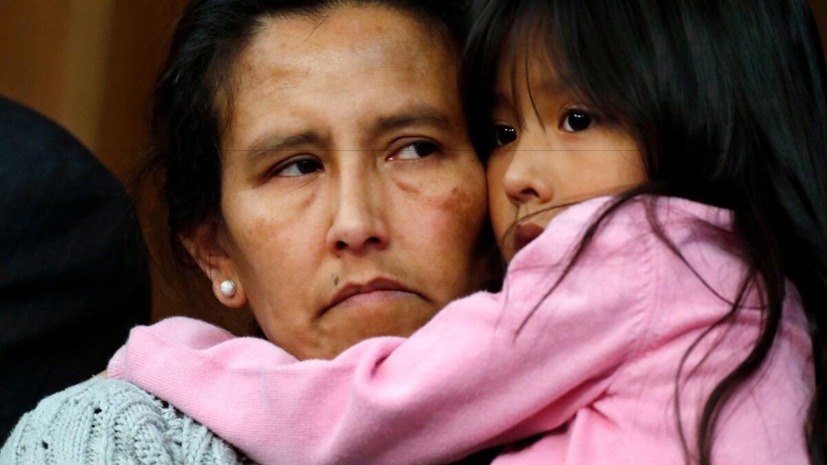 Jeanette Vizguerra, a Mexican woman seeking to avoid deportation from the United States, cradles her 6-year-old daughter, Zury, during a news conference Feb. 15 at a church in Denver where she and her children have taken refuge.