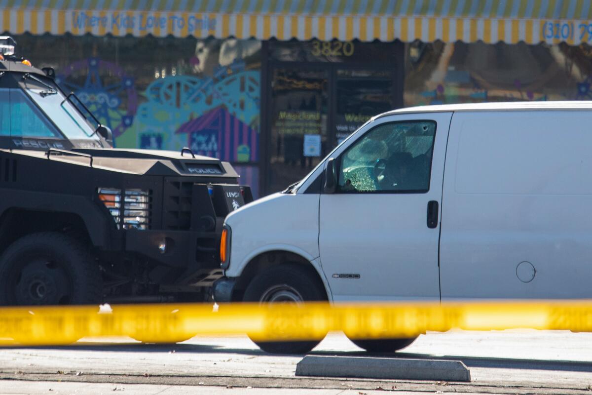 The driver of a white van appears slumped over the steering wheel.