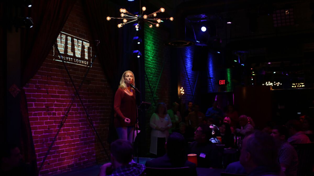 The Rev. Bobbi Becker, with InSpirit Center for Spiritual Living, speaks during an OC Faith-Leader Collective vigil for Orlando's victims at the Velvet Lounge, a gay club in Santa Ana.