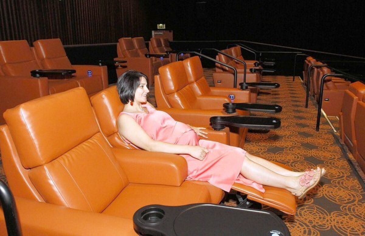 Sitting on a leather chair is Lucy Manasyan, one of the owners of the new Five Star Cinema on North Maryland Avenue in Glendale. The theater held its soft opening Wednesday, August 7, 2013.